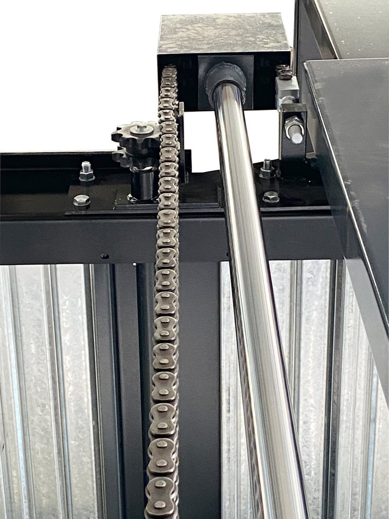 Close-up of the roller chain, sprocket and chrome hydraulic cylinder rod on the Olympic 2PTS-8800 triple stacker